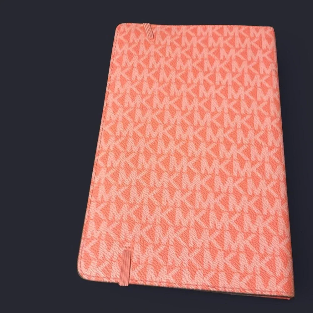 MK pink/red leather organizer/planner cover with repeating MK monogram pattern